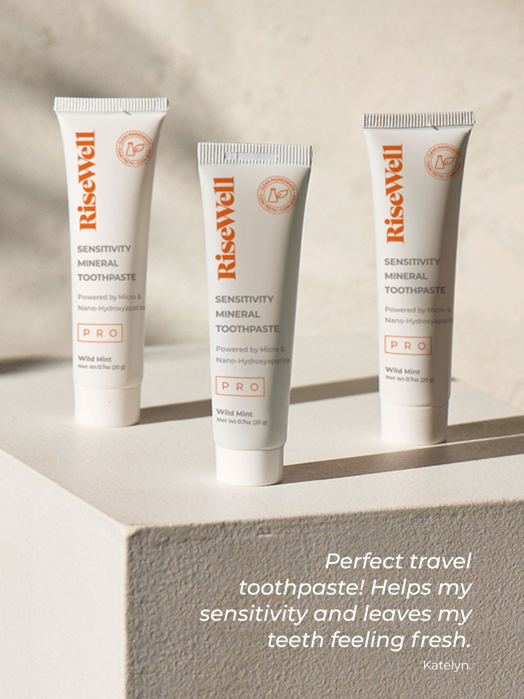 Three tubes of RiseWell toothpaste on a light surface with a neutral background.