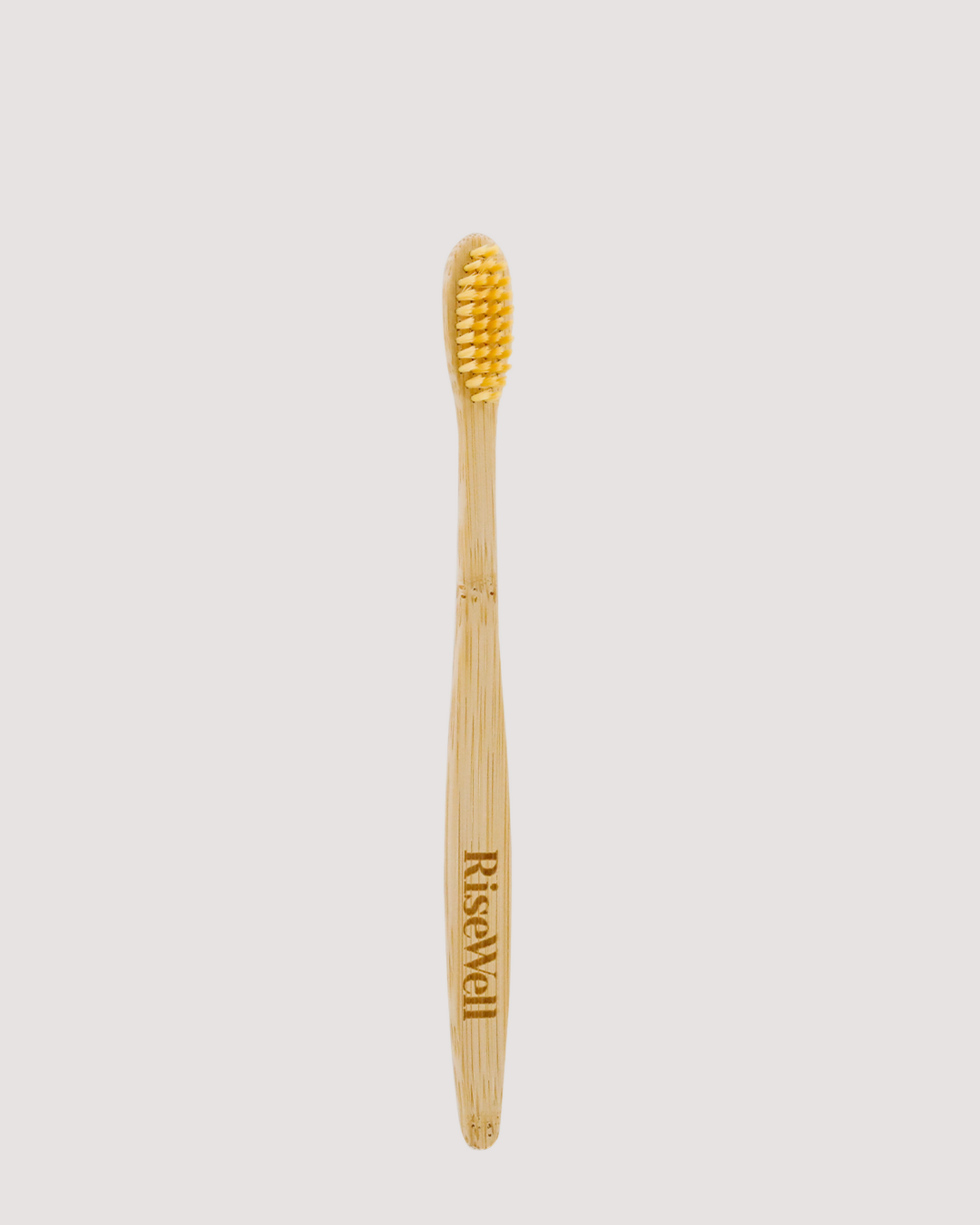 RiseWell Bamboo toothbrush on a light gray background