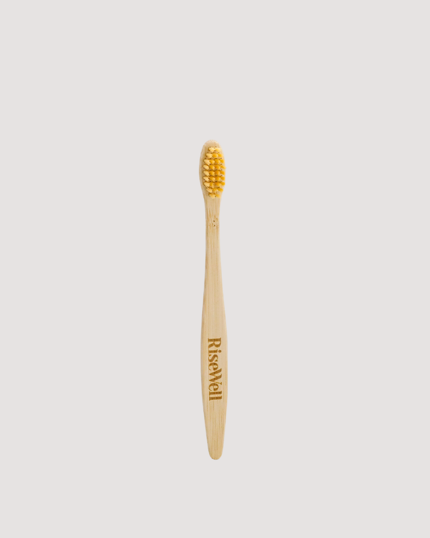 RiseWell Bamboo toothbrush on a light gray background