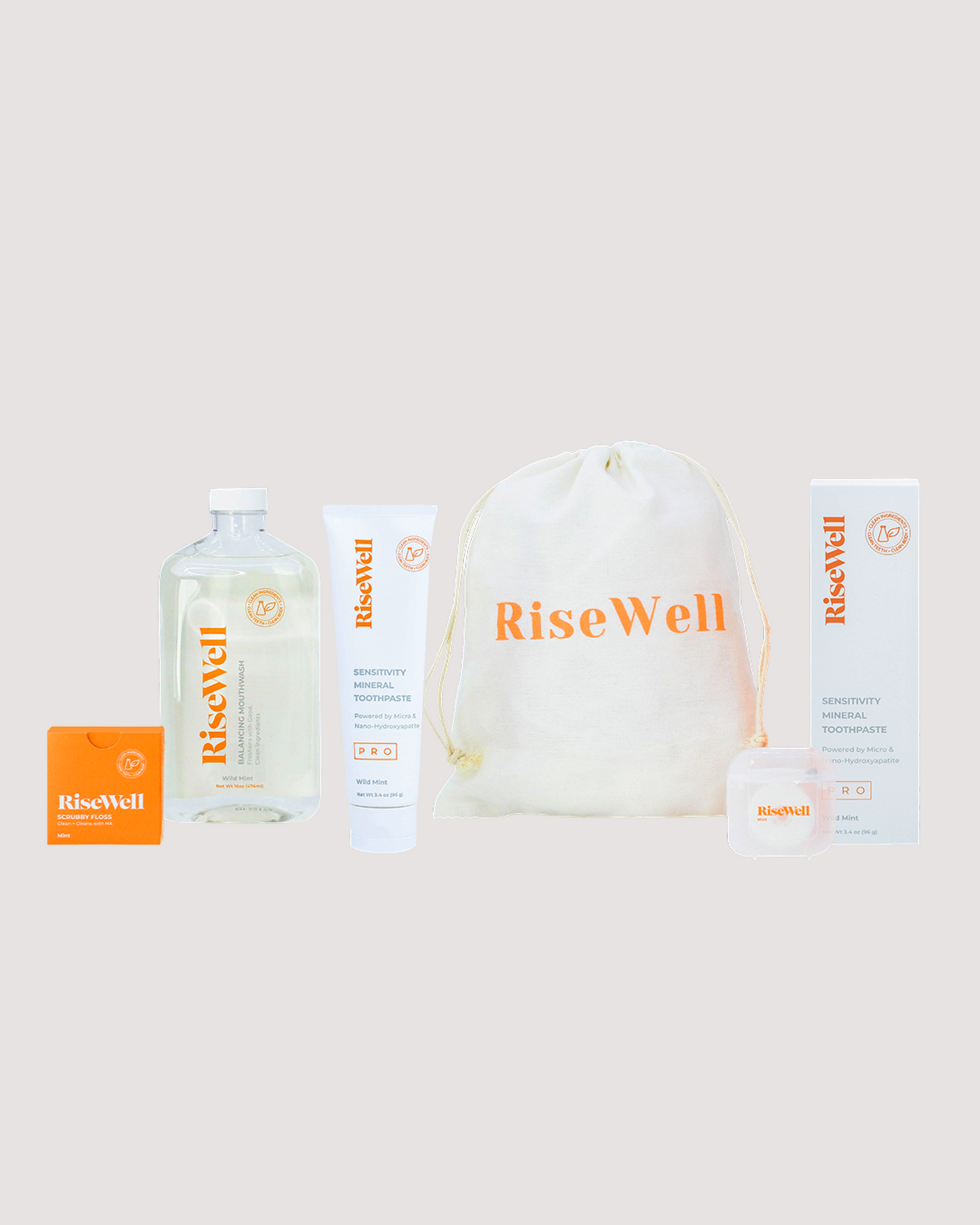 Collection of RiseWell products including a bottle, pouch, and boxes on a light background