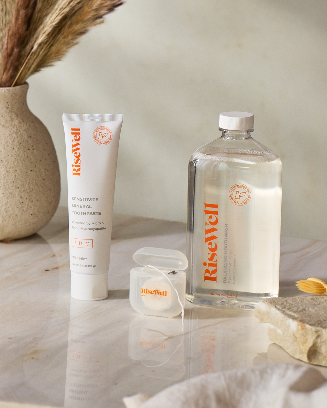 RiseWell products on a marble surface with a neutral background