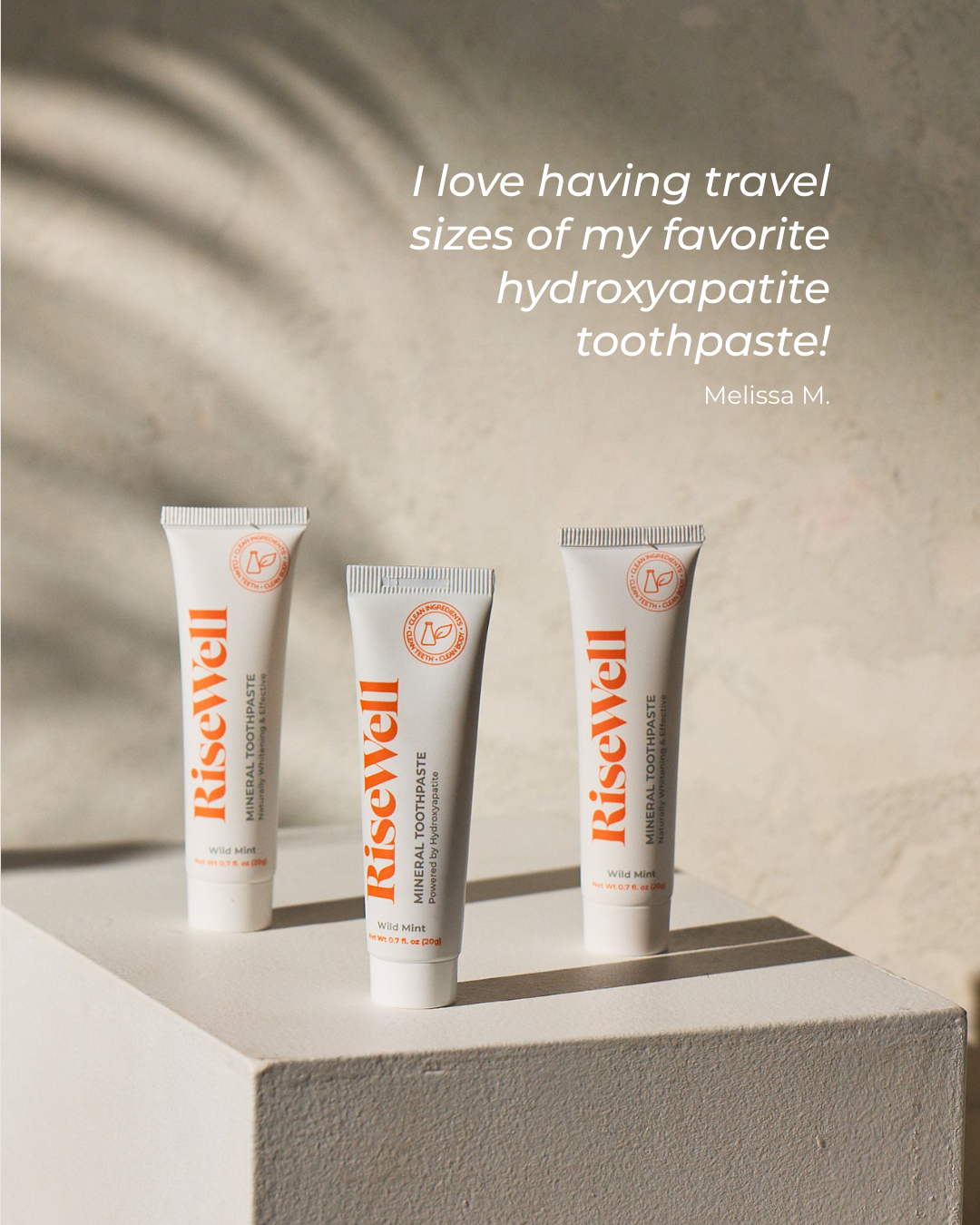 Three tubes of RiseWell toothpaste on a light surface with a neutral background